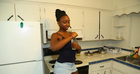 Tempting black milf Naomi Gamble in skirt denudes big boobs and hot butt 